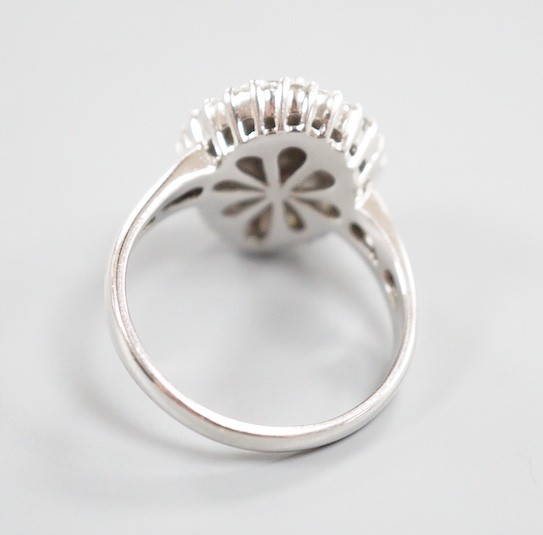 A modern 14ct white gold, baguette and round cut diamond cluster set pear shaped dress ring, size R/S, gross weight 6.7 grams
